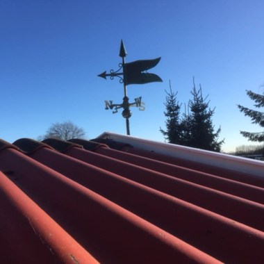 verdigris banner weathervane installed